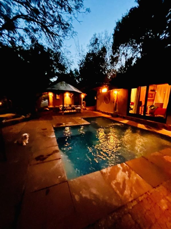 Pool at night Authentic nature retreat styled with cozy, repurposed old-world charm